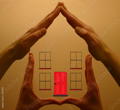 hands holding red house