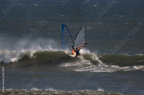 sailboarders ride  waves at punta san carlos photo