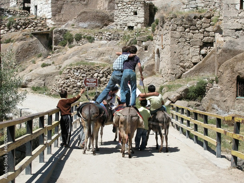 boys riding donkeys in ihlara valley. cappadocia,