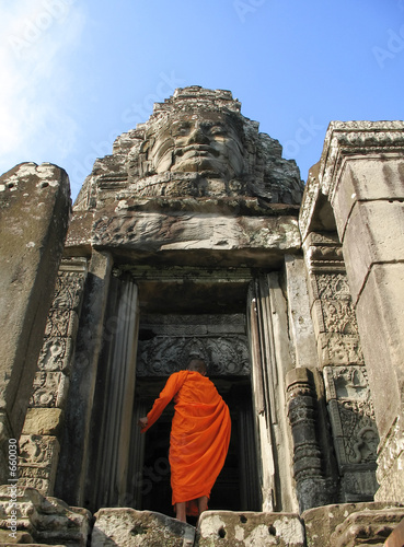 a monk enters bayon temple at angkor thom, cambodi