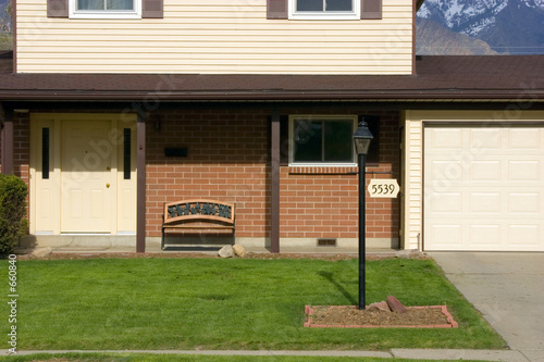 front of a house with mountains on the background
