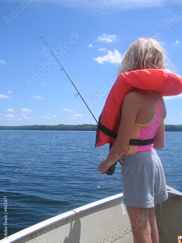 girl with life jacket fishing