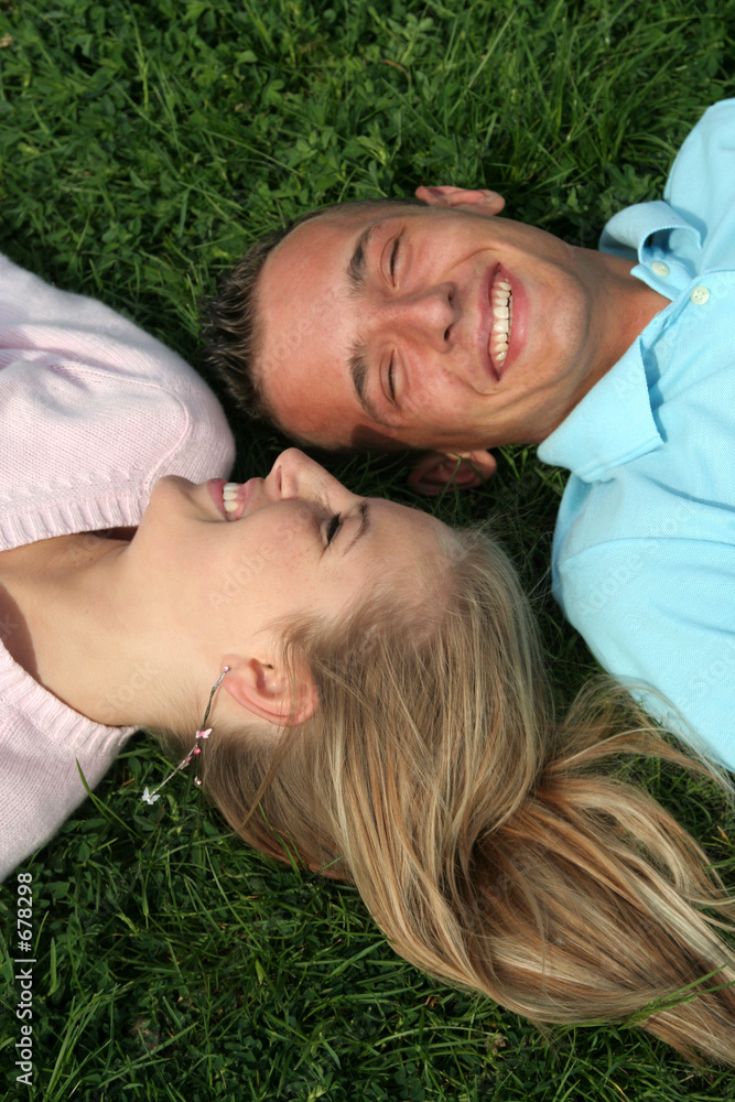 couple lying on the grass couple lying on the grass