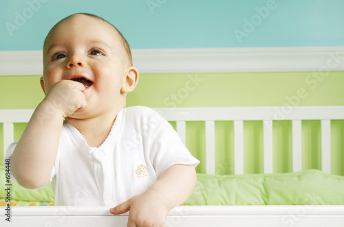 baby boy smiling in crib
