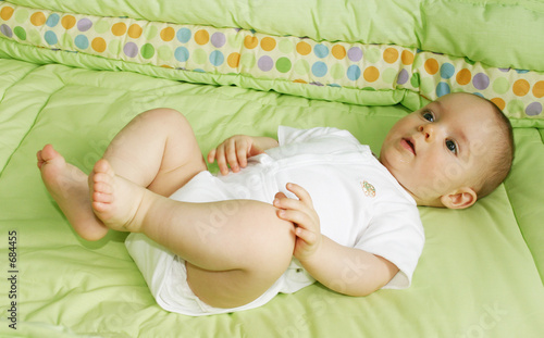 baby boy playing in crib photo