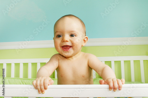 baby boy playing in crib