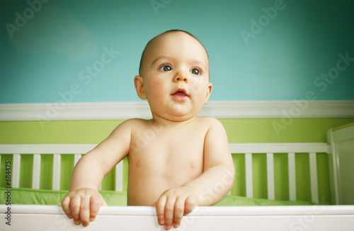 baby boy playing in crib