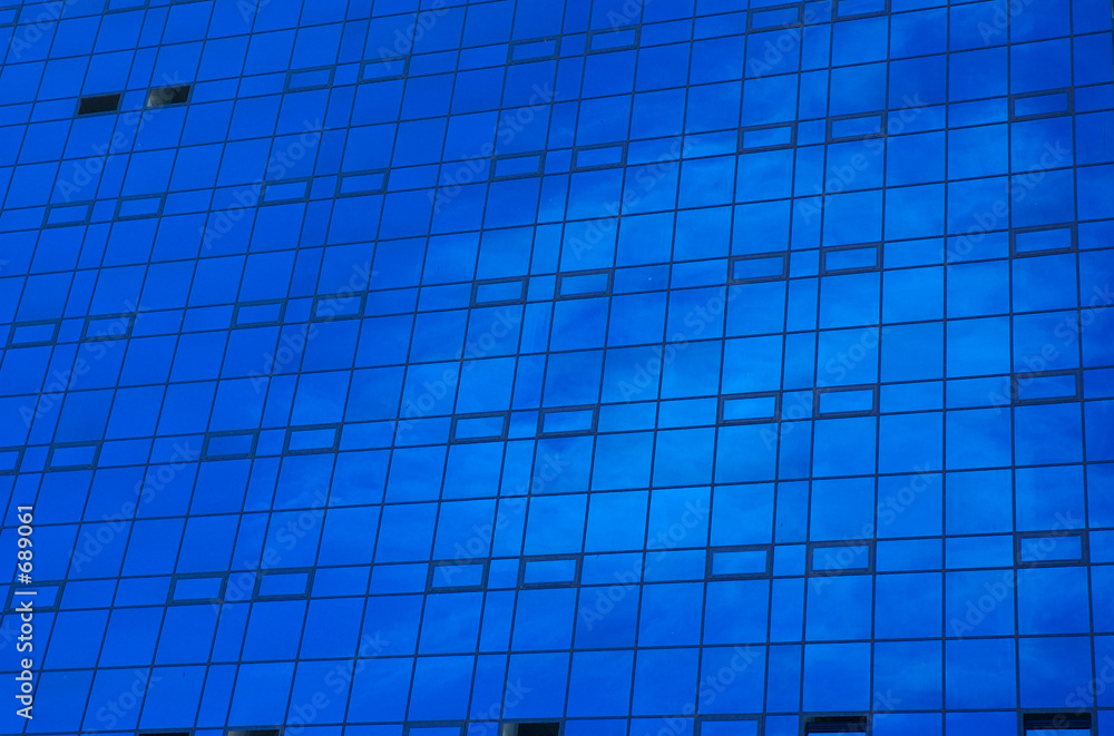 office building with cloud's reflections in window office building with cloud's reflections in window