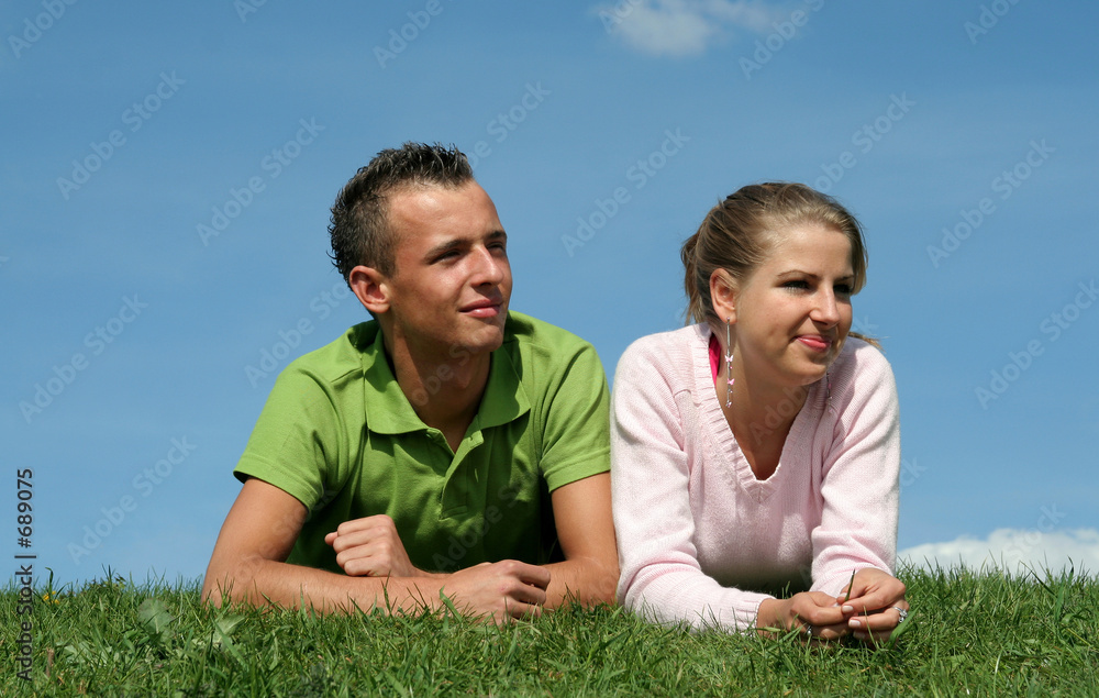 couple lying on the grass couple lying on the grass