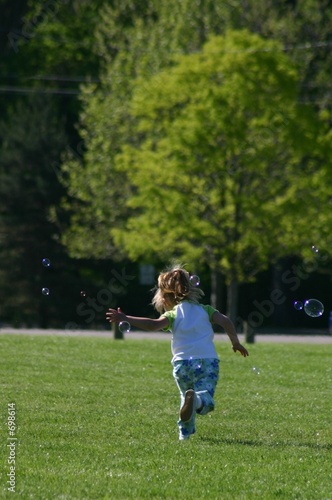 girl chasing bubbles