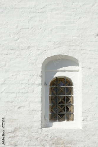 window in a wall of monastery © javarman