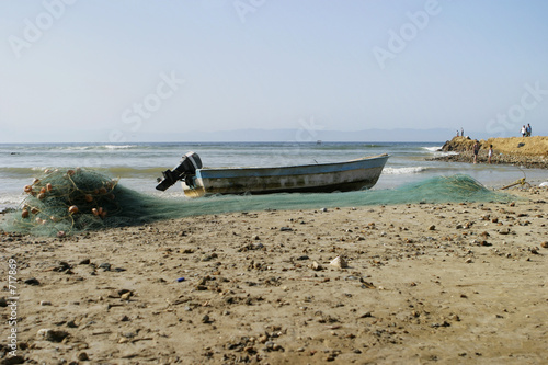 fishing boat and net on the beach