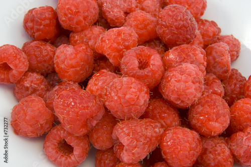raspberries in white bowl