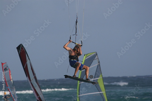 kiter jumping amongst windsurfers