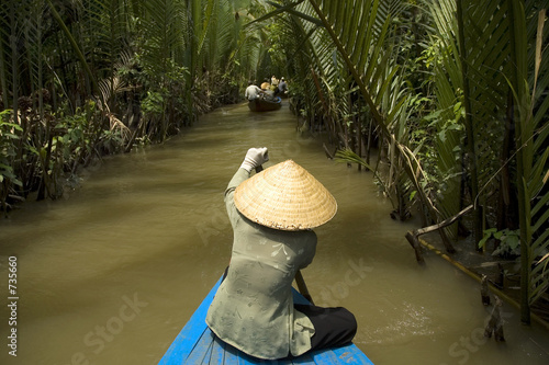 vietnamese woman rowing a boat