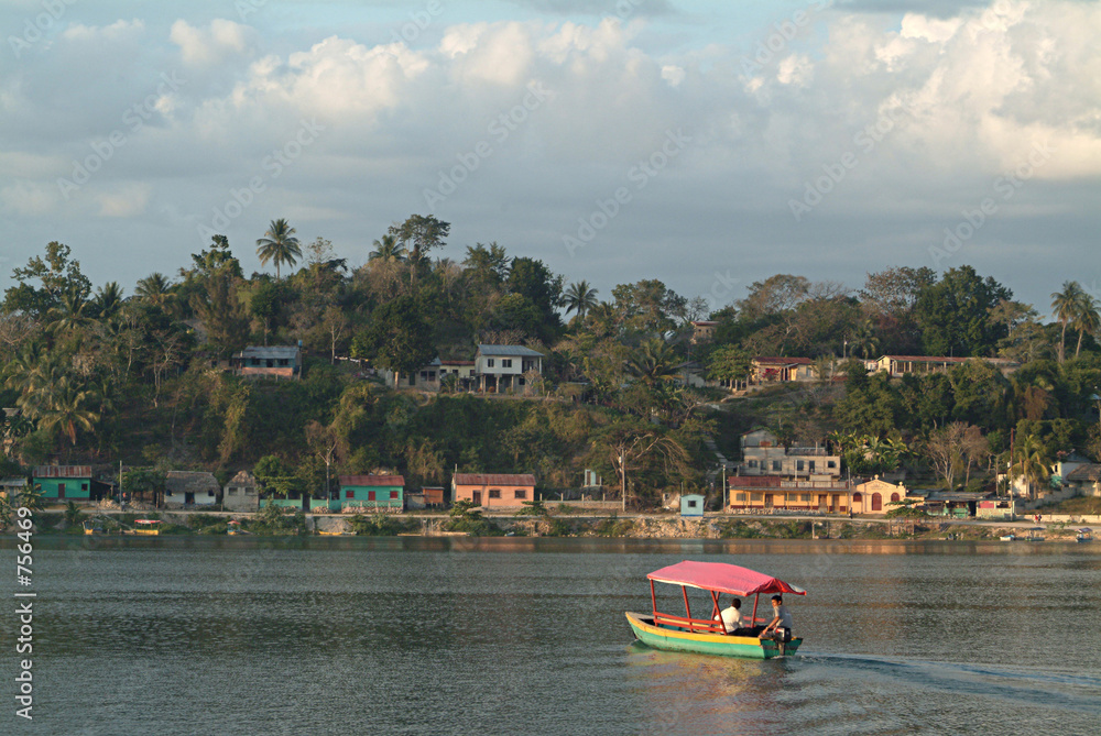 Fototapeta premium small colorful water taxi crosses lake in flores,