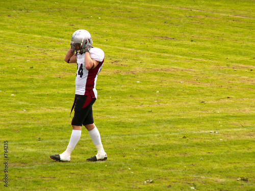 american football player leaving the field