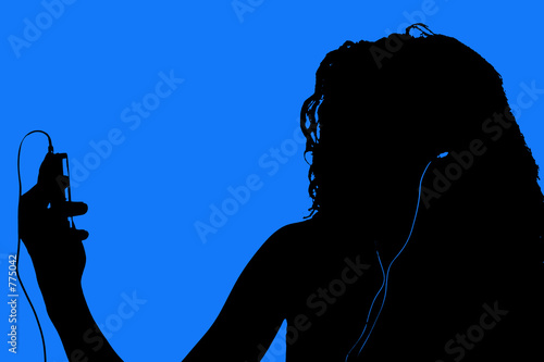 silhouette of teen with digital video player photo