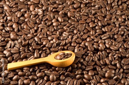 wood spoon on coffee beans