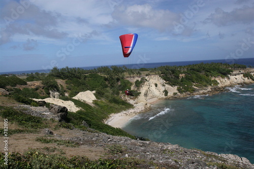 paraglider soaring over barbados coastline