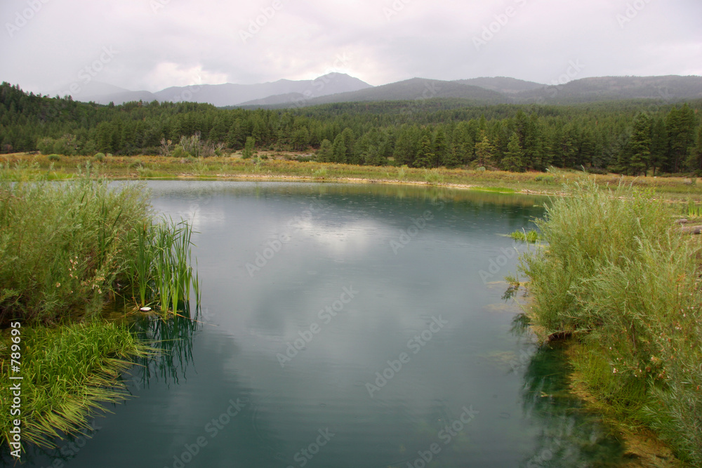 blue lake with mountains in the background