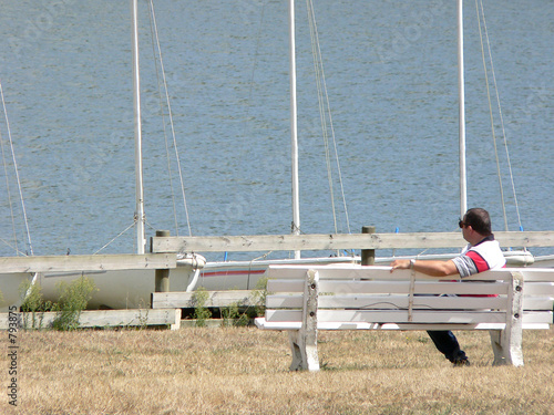 the lonely man which sits on a bench