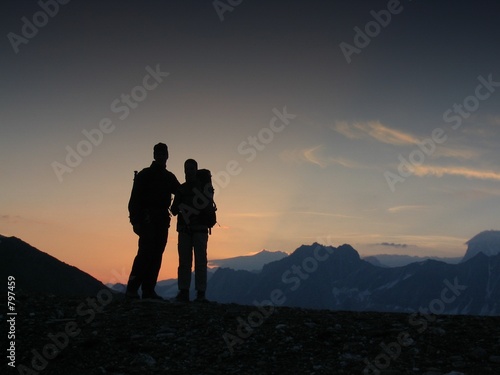 two climbers watching a sunrise
