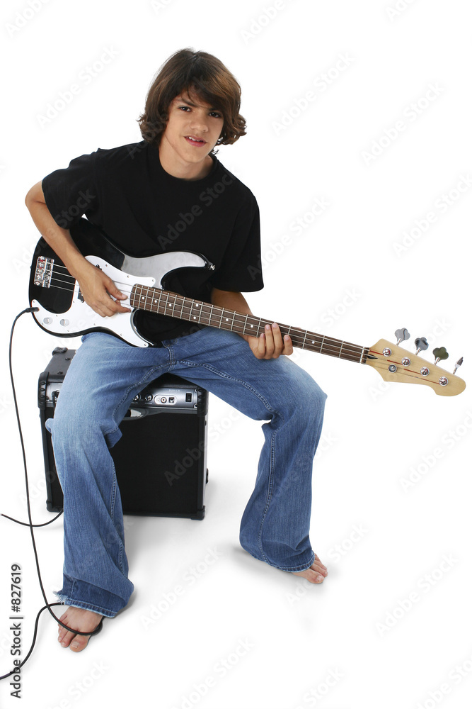 boy with black and white bass guitar sitting on am boy with black and white bass guitar sitting on am