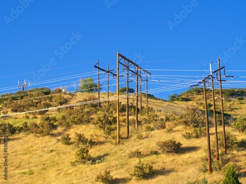 disorderly power lines on hill photo