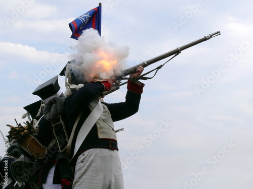 Canvas Print a soldier firing a rifle