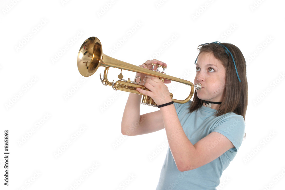 Foto de young pre teen girl playing trumpet 1 do Stock