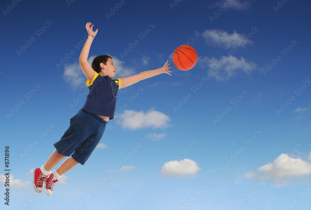 boy playing basketball jumping and flying