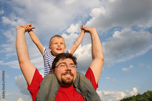 father with son on shoulders