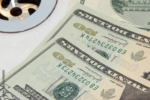us banknotes going down the drain