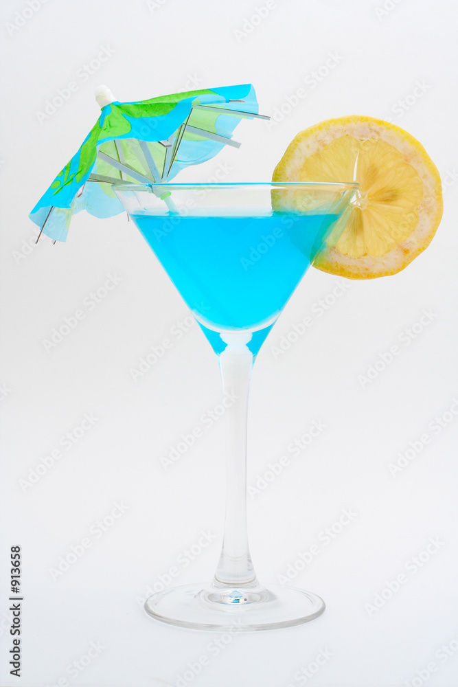 detail of blue cocktail with lemon and unbrella detail of blue cocktail with lemon and unbrella