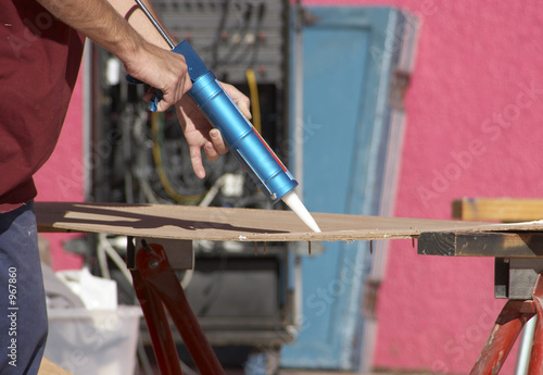 tradesman using a glue gun