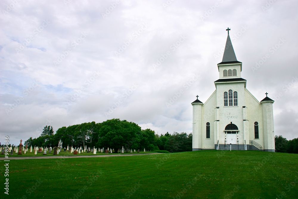 country church and its cemetery under a stormy sky