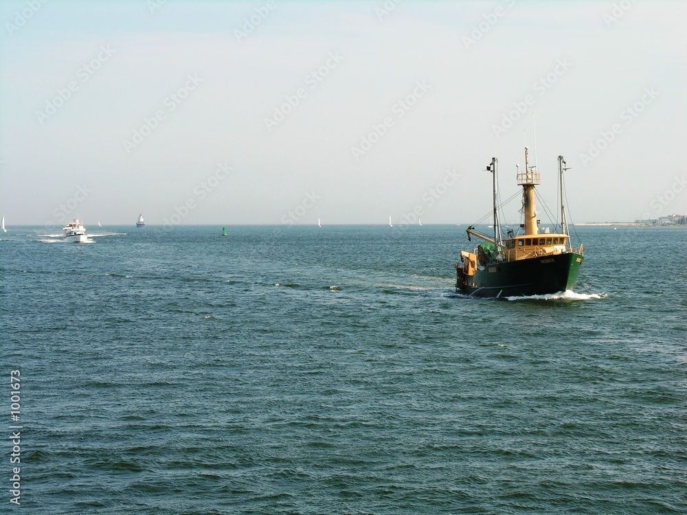 a fishing boat approaching the harbor