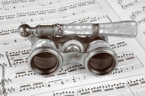 antique opera glasses on a music score