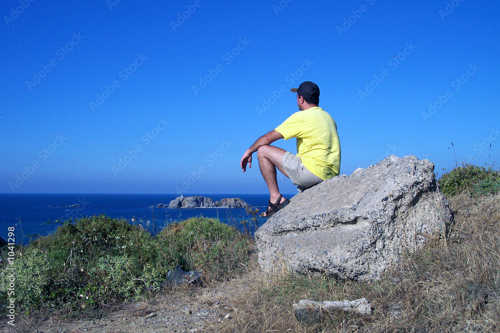 man on the rock watching the nature