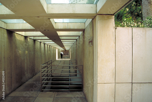 man in business suit walking in underground tunnel