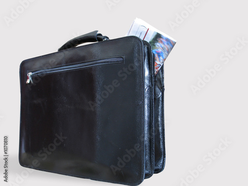 a casual briefcase and a newspaper inside it photo