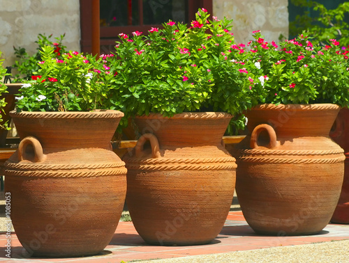 three coiled clay pots