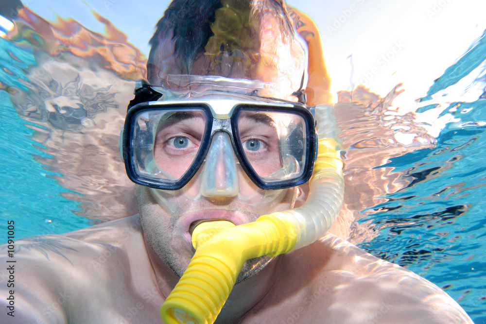 man snorkelling in a swimming pool