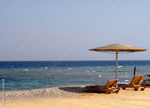 beach chairs and umbrella