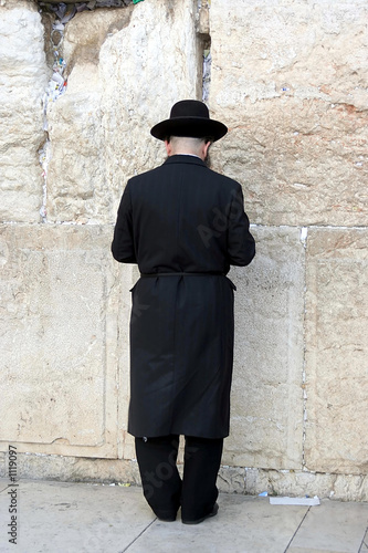 a man praying at the western wall