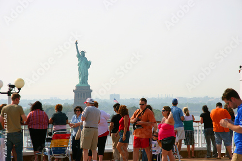 people looking at the statue of liberty