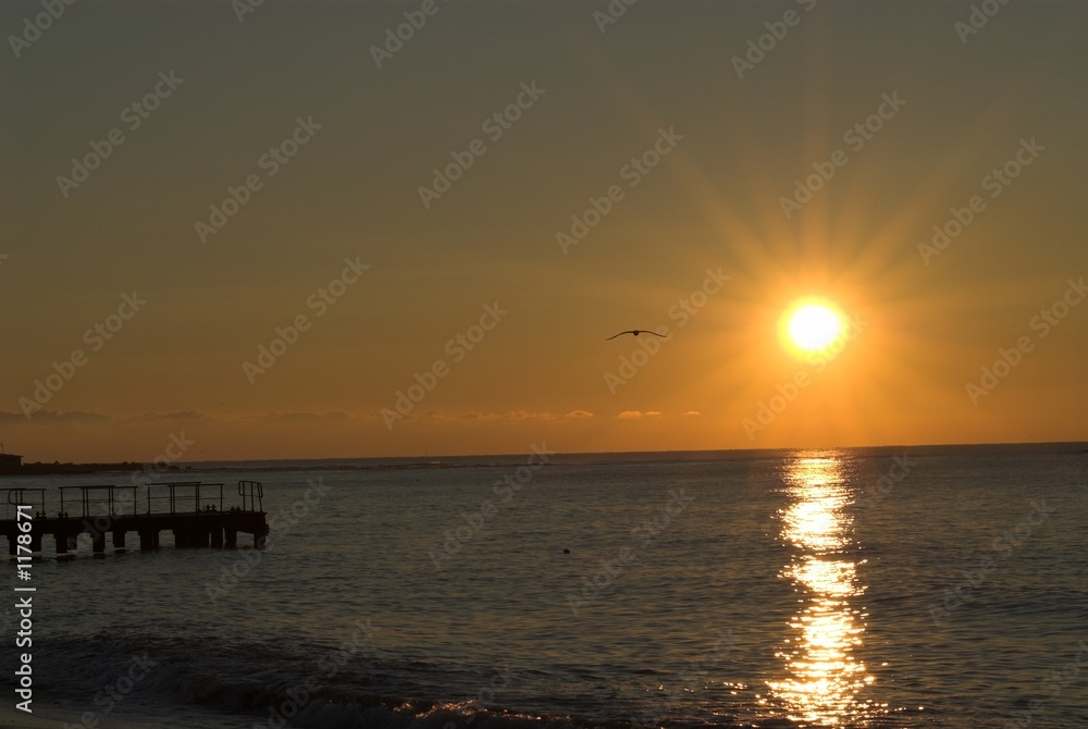 sunrise on black sea with pier silhouette
