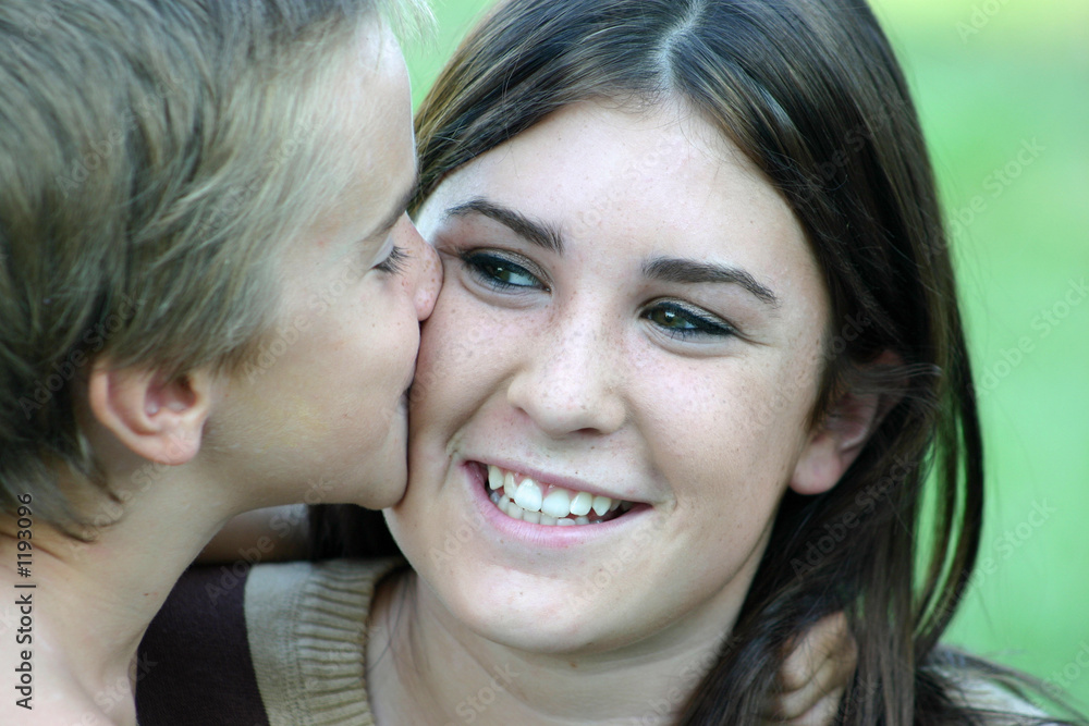 boy kissing girl on cheek boy kissing girl on cheek