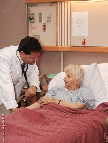 doctor taking senior blood pressure